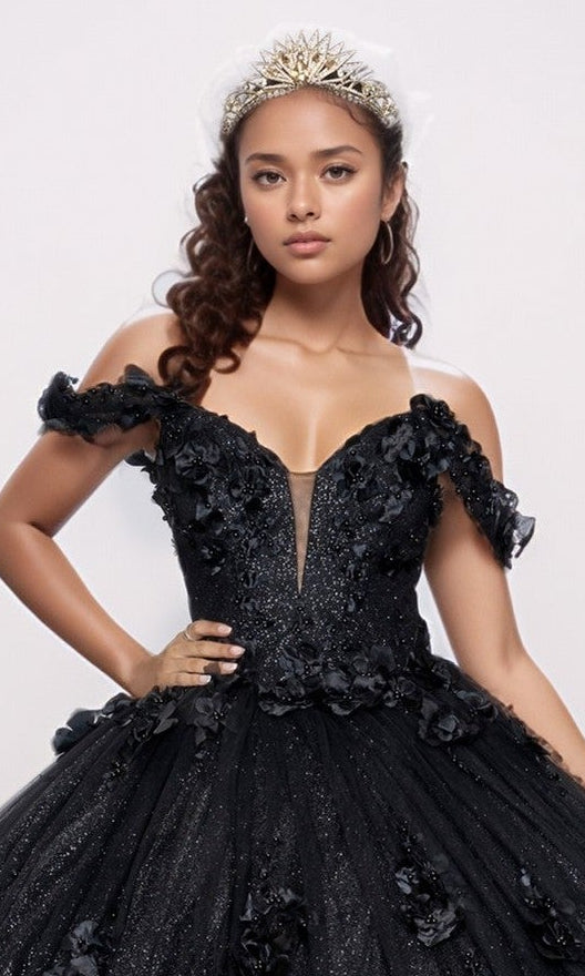 Young woman in the Quinceanera Dress Q2444 by Nina Canacci, featuring a black glitter tulle skirt and 3D floral appliques, wears a jeweled tiara while standing against a plain background.